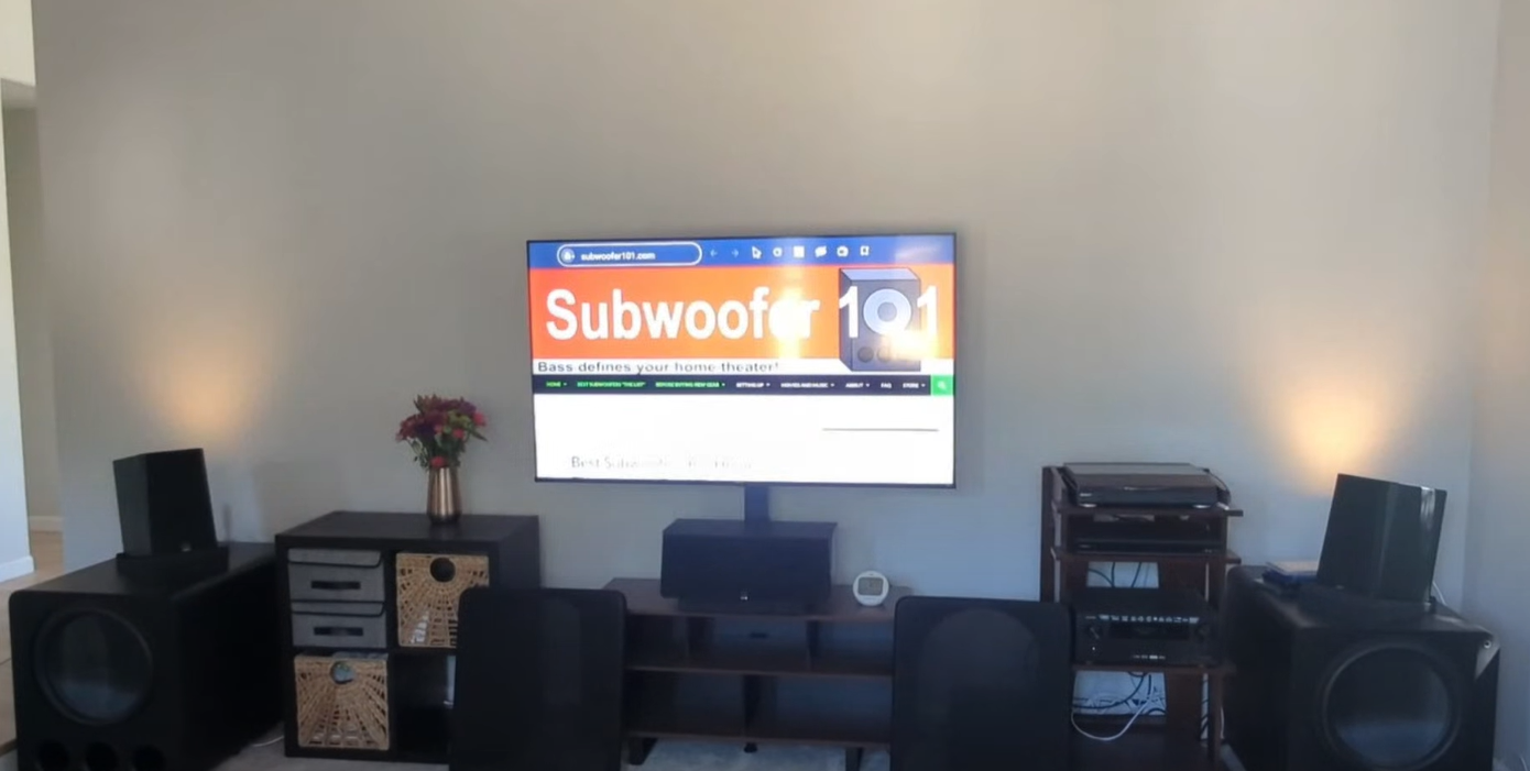 Two subwoofers corner loaded at the far left and right of the theater room